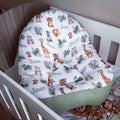 Crib with a white comforter featuring animal prints and the brand 'Juwan'.