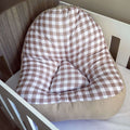 Checkered lounger cushion on a chair with a neutral background