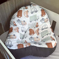 Baby bouncer with truck pattern in a crib