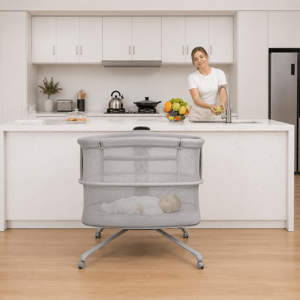 Woman standing in a kitchen with a grey dream starlight crib in the foreground
