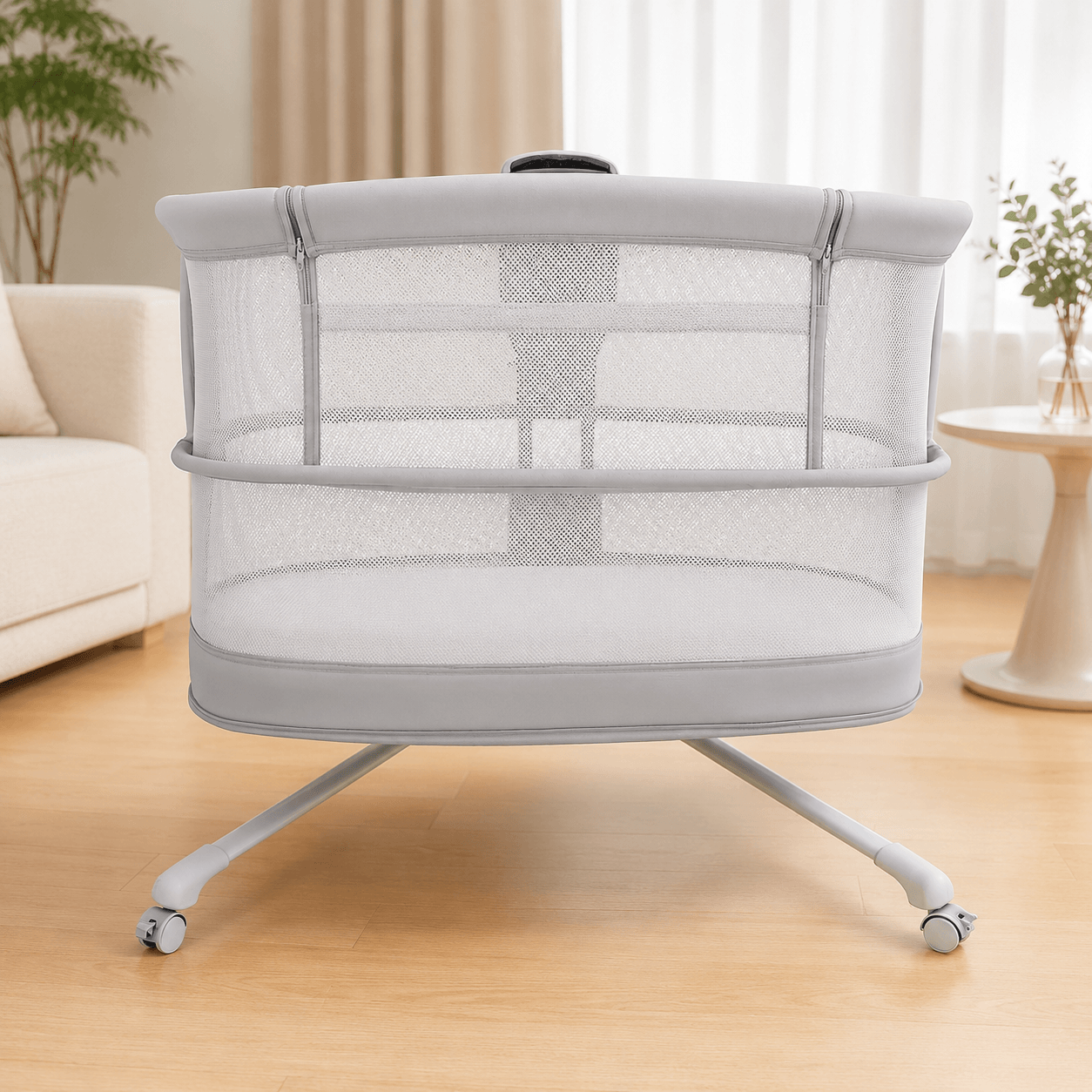 Portable dream starlight crib with mesh sides on a wooden floor in a room with a couch and plants.