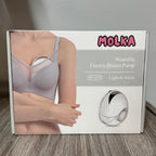 Box of MOLKA wearable electric breast pump on a wooden floor.