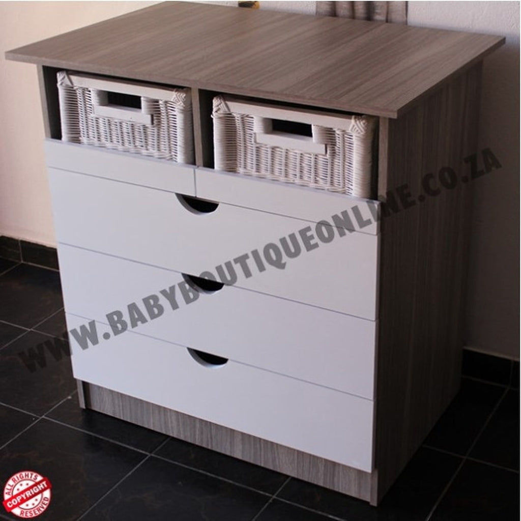 Wooden dresser with white drawers and wicker baskets on a tiled floor.