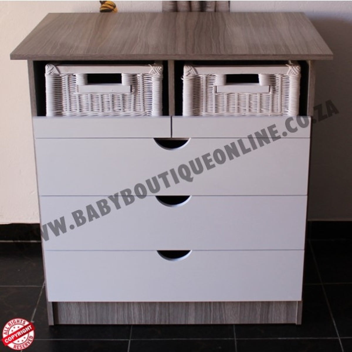 White dresser with three drawers and two wicker baskets on a tiled floor.