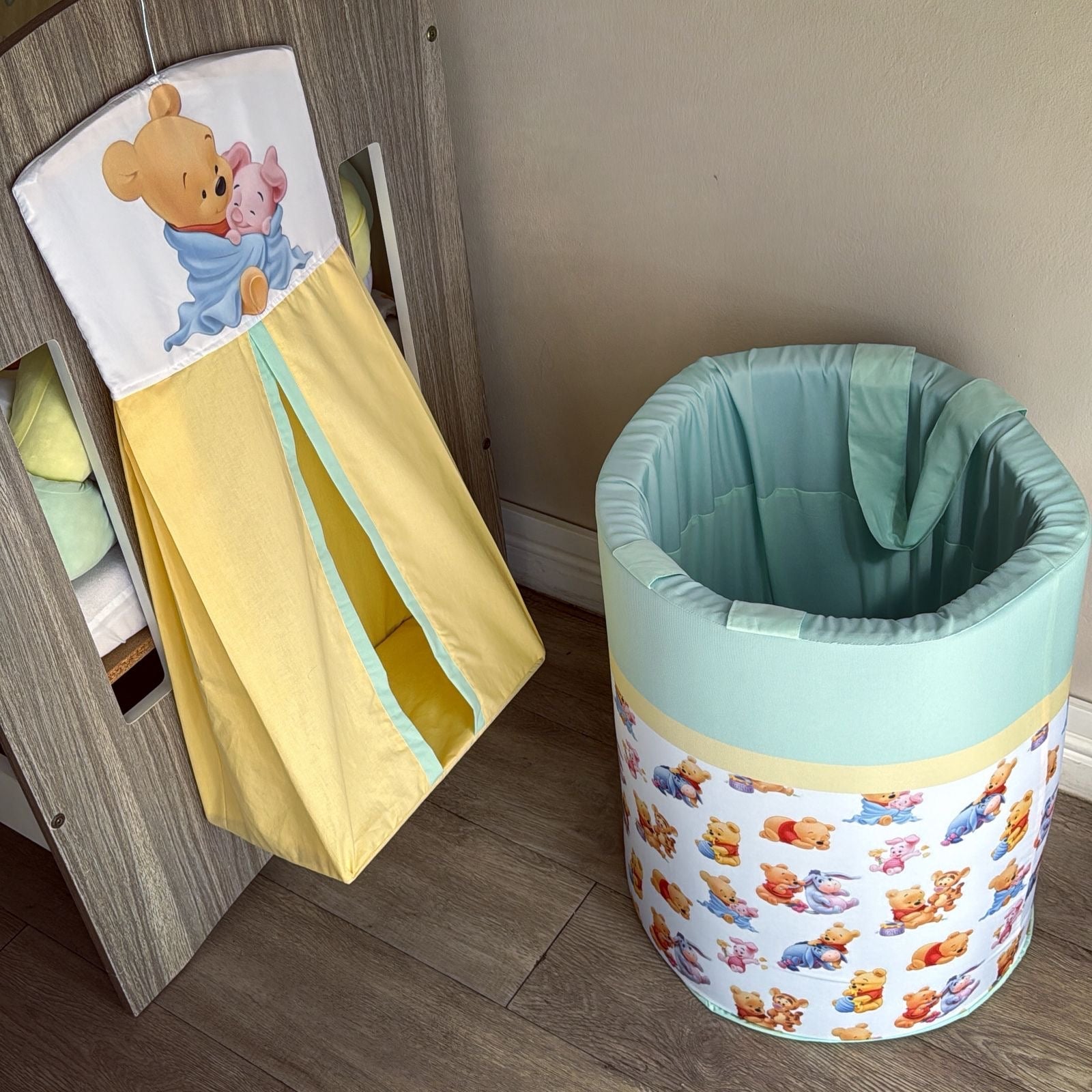 Children's toy storage bin with cartoon design on a wooden floor.