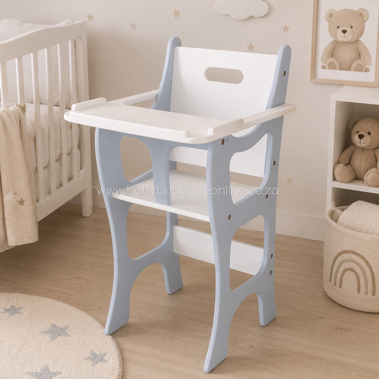 A light blue and white wooden toddler high chair placed in a softly styled nursery room next to a white crib, with a teddy bear shelf and rug in the background.