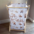 Baby changing table with teddy bear and cloud pattern on a wooden frame