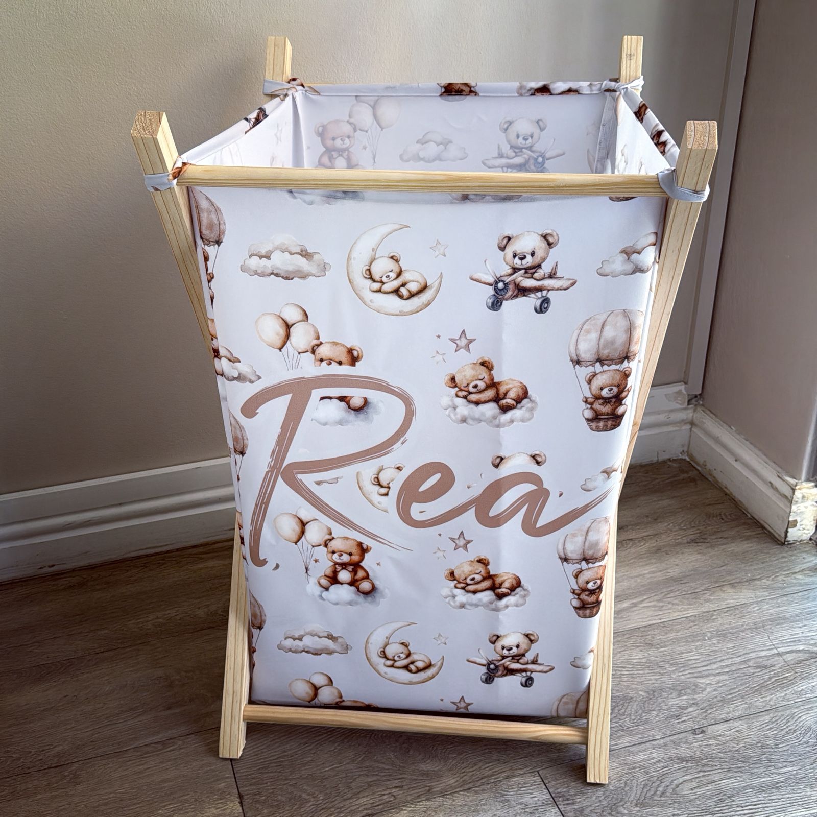 Baby changing table with teddy bear and cloud pattern on a wooden frame