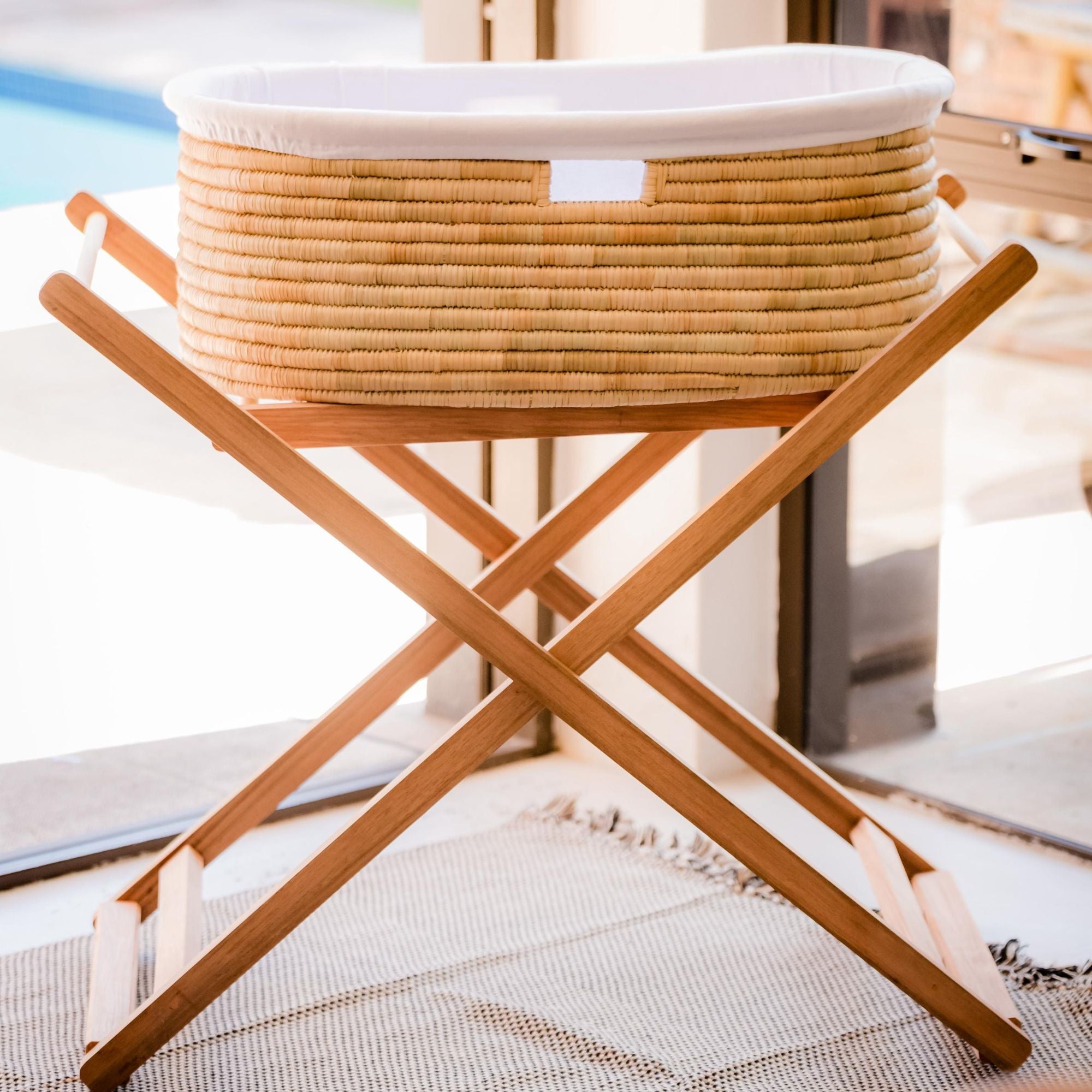 Wicker laundry basket on a wooden stand with a blurred background
