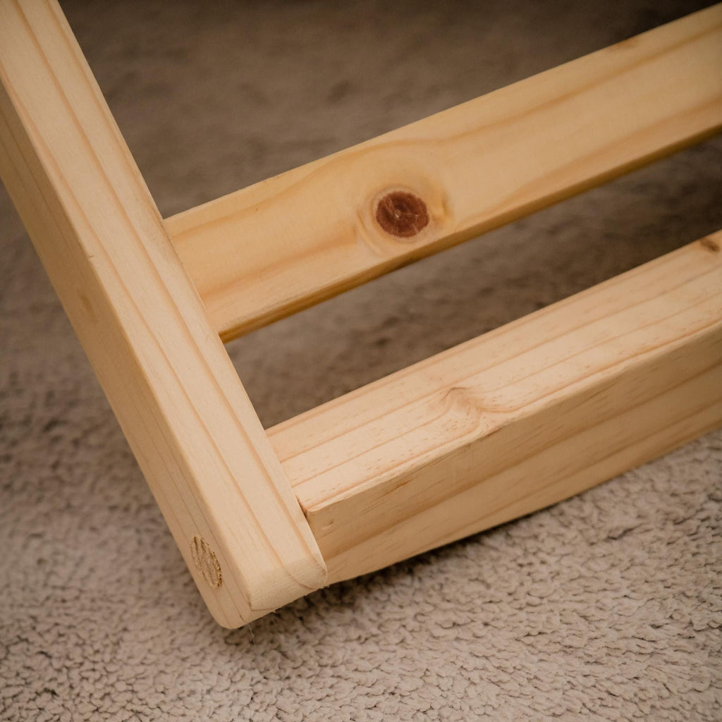 Close-up of a wooden frame on a carpeted floor